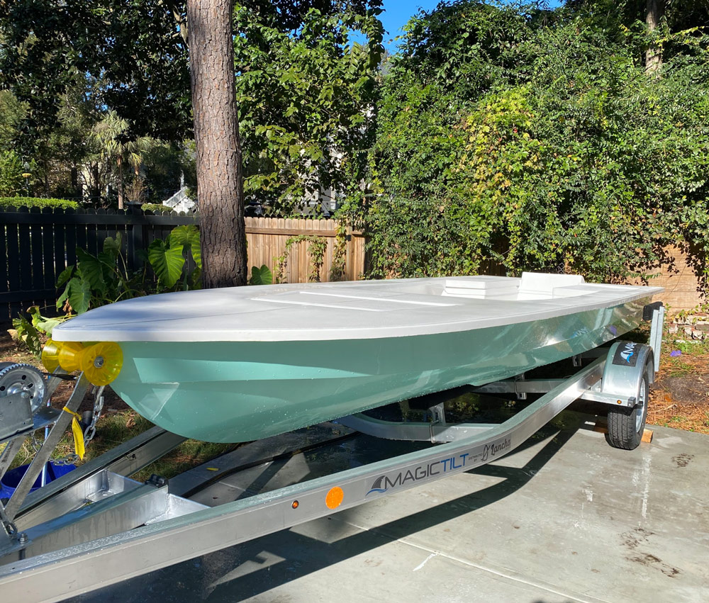 Seafoam coastal skiff on aluminum trailer