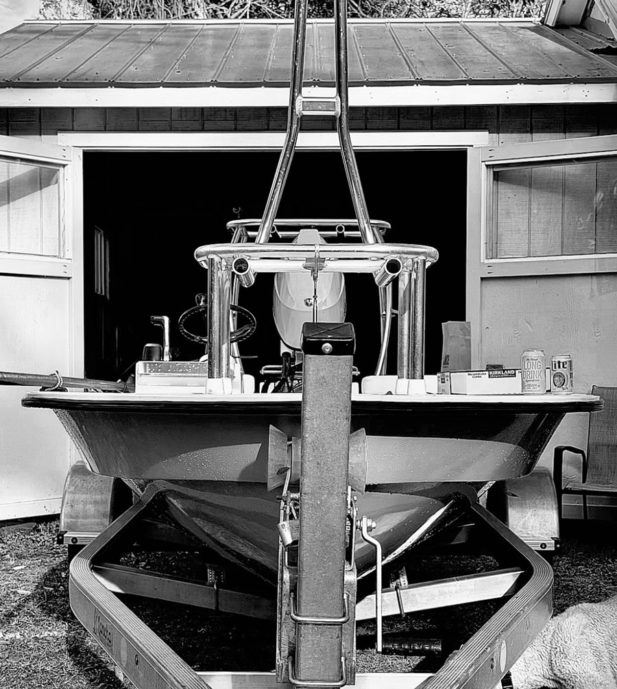 Lancha skiff on trailer in front of the shop